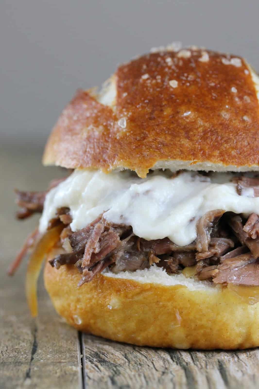 Close up of Shredded Beef and Horseradish Sandwich on a wood counter.