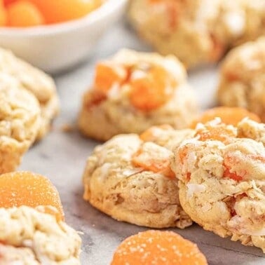 Orange slice oatmeal cookies on a marble tabletop.