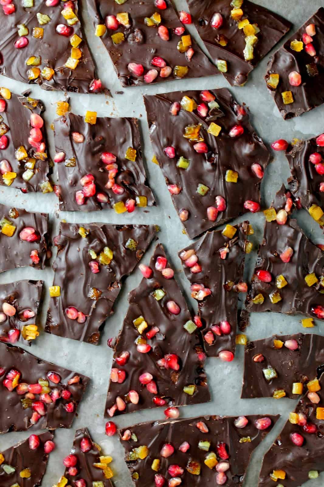Rich chocolate bark sprinkled with fresh pomegranate and orange makes an easy to make and elegant treat