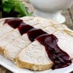 Slices of turkey breast drizzled with cranberry sauce