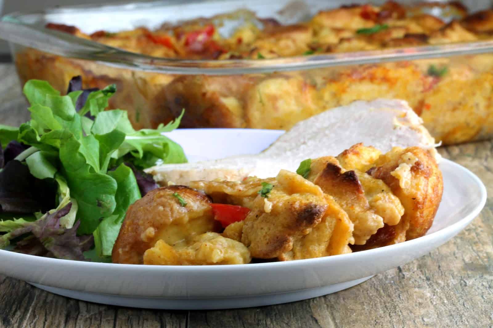 Southwestern Stuffing with Bacon, Jalapeno, and Bell Pepper topped with a slice of turkey breast and accompanied by a side salad