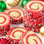 A stack of Spiral Christmas Sugar Cookies with swirls of red, green and white and rolled in green, red and white sprinkles