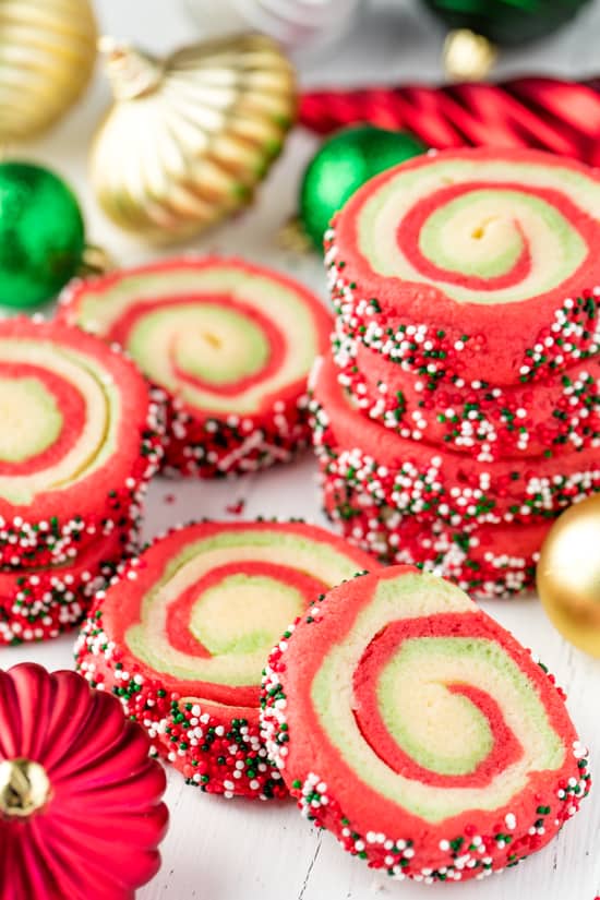 A stack of Spiral Christmas Sugar Cookies with swirls of red, green and white and rolled in green, red and white sprinkles