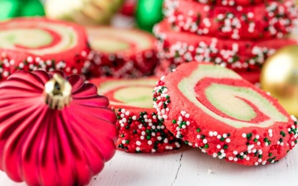 Spiral Christmas sugar cookies with a Christmas ornament.