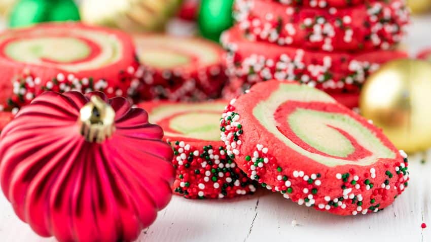 Spiral Christmas sugar cookies with a Christmas ornament.
