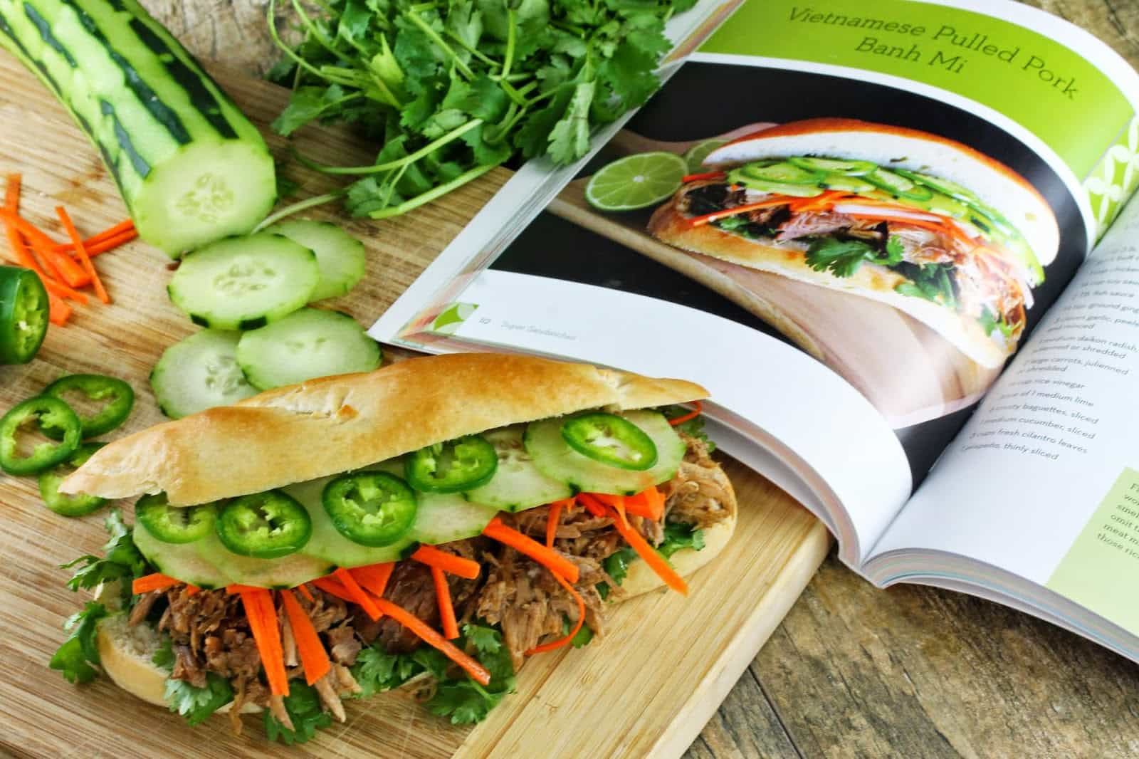 Vietnamese bahn mi sandwich with sliced cucumbers on a cutting board