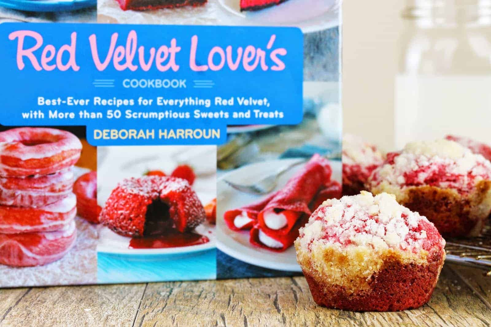 Cream cheese muffin sitting next to the Velvet Lover's cookbook