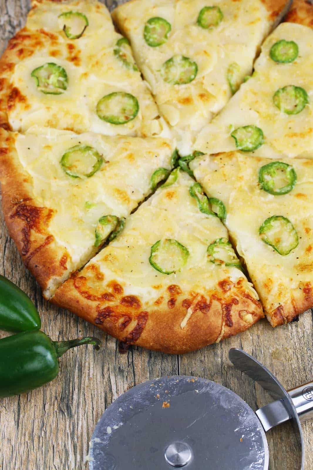 Jalapeno Scalloped Potato Pizza: The creamy texture of scalloped potatoes, the crunchy texture of bubbly cheese on a pizza crust, and the spice of jalapeno. 