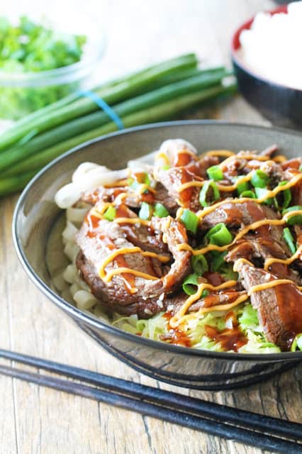 Rice noodles, rice, and cabbage, topped with delicious Korean bulgogi, drizzled with sriracha mayo and Korean barbecue sauce....it's seriously so good!