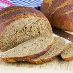 Sliced dark rye bread on a table.
