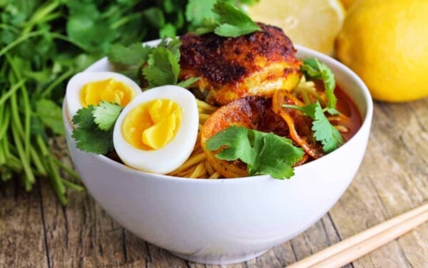 Moroccan Ramen in a white bowl topped with cilantro leaves.