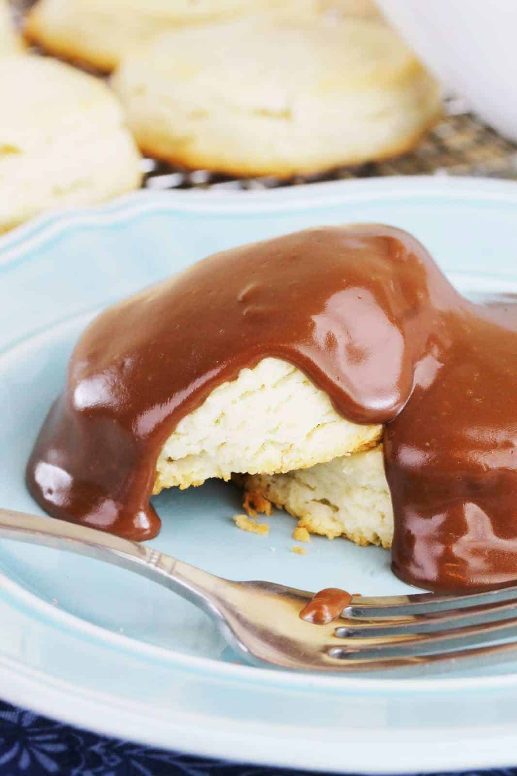 Close up of Sweet Biscuits with Chocolate Gravy on a blue plate.