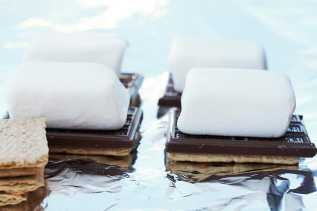 S'mores are made by stacking half a graham cracker, half a chocolate bar and a marshmallow on top