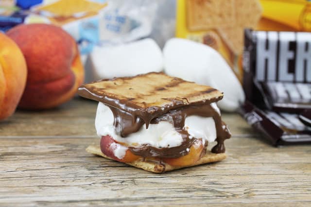 Grilled Peach grilled s'more stacked with melted chocolate, gooey marshmallow and grilled peach