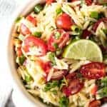  and cherry tomatoes in a white decorative bowl Cilantro-Lime Orzo Pasta Salad