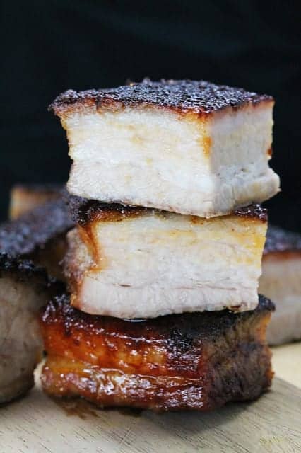 Stacked cut up pieces of crispy roasted pork belly