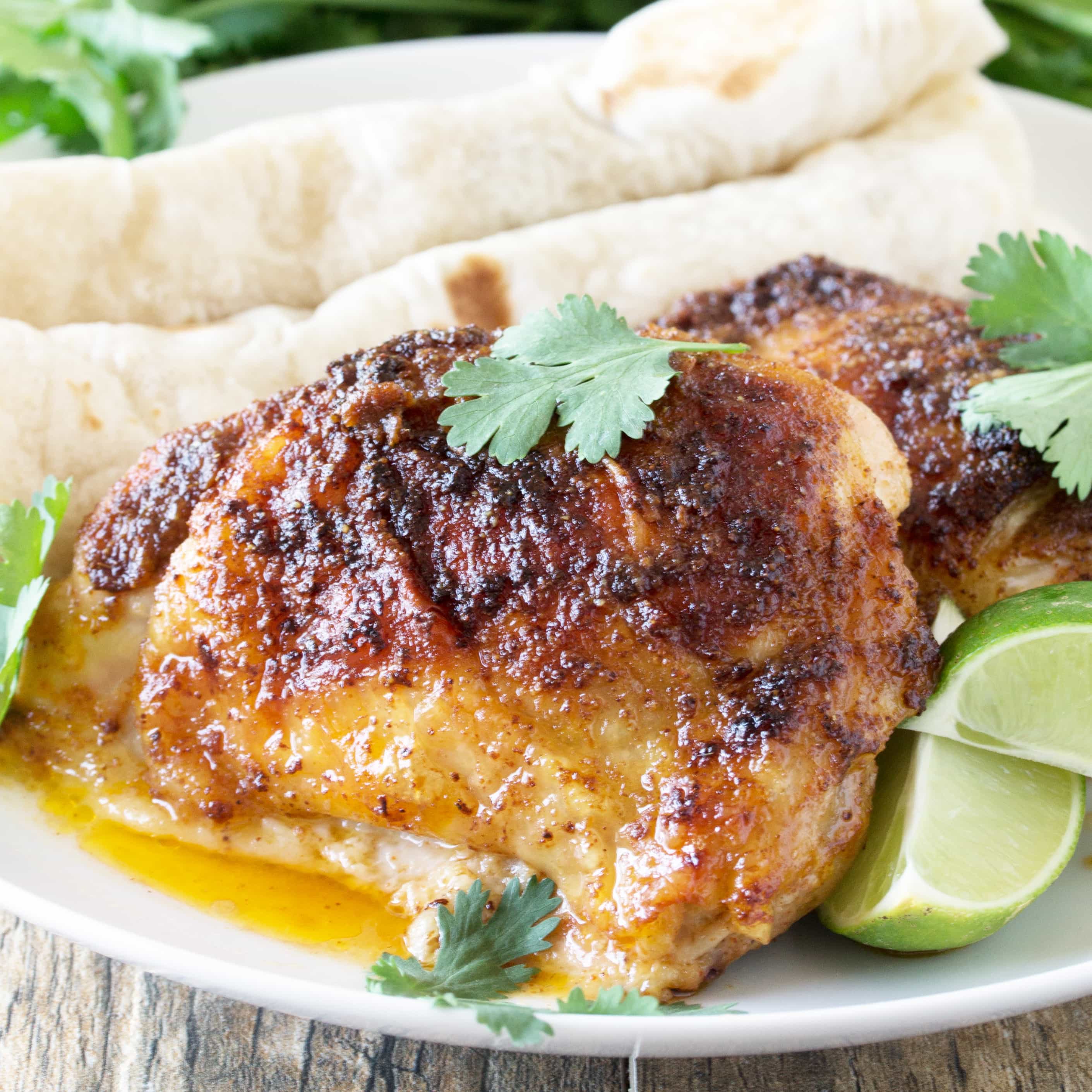 Chicken Thighs on a white plate.