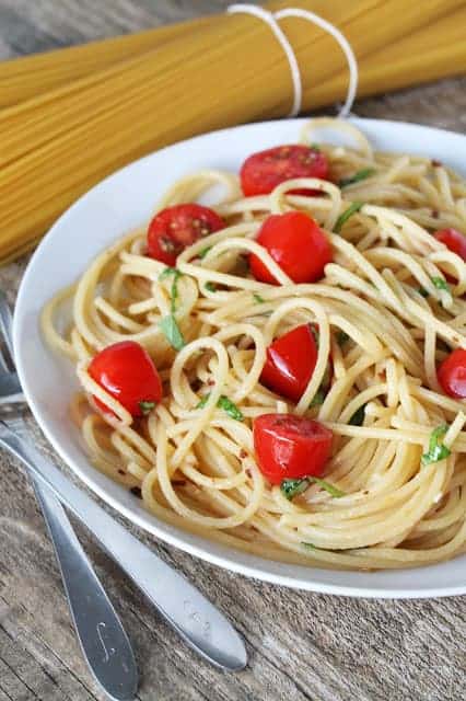 tomato, basil and garlic brown butter pasta in a white bowl