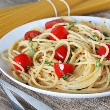 Garden Fresh Tomato Basial and Garlic Brown Butter Pasta on a white plate.