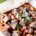 Mexican Beef Stir Fry with Bacon and Jalapeno garnished with fresh cilantro and served with a warmed tortilla