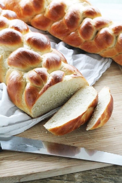 Challah Bread with two slices cut out of it.