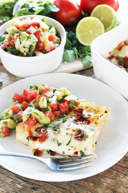 Spicy Bacon Lasagna with onion, jalapeno, and cilantro. Top it off with a fresh avocado salsa for a spic spin on classic lasagna. And, hello! Bacon!