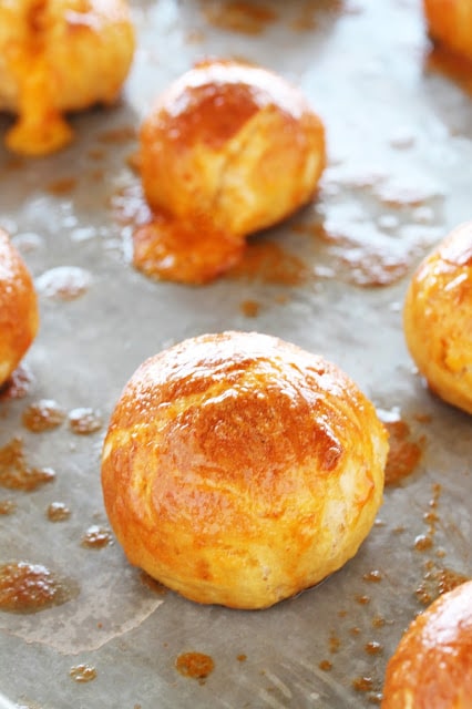 Cheddar Stuffed Sriracha Pretzel Bites are one of the best appetizers ever. It's hard to beat gooey melted cheddar inside a soft and chewy sriracha-flavored pretzel.