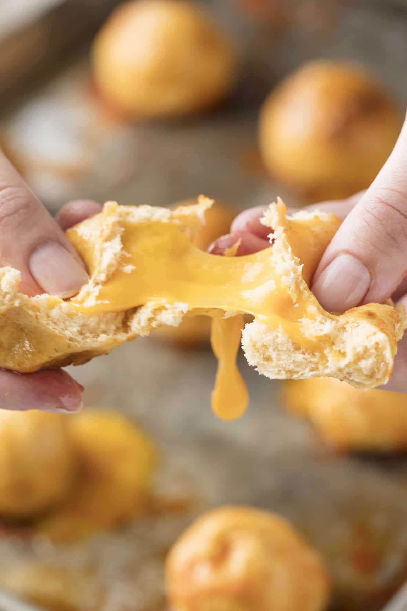 Cheddar Stuffed Sriracha Pretzel Bites are one of the best appetizers ever. It's hard to beat gooey melted cheddar inside a soft and chewy sriracha-flavored pretzel.