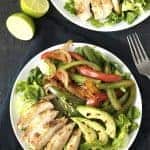 Fajita Salad on a white plate on top of a black towel.