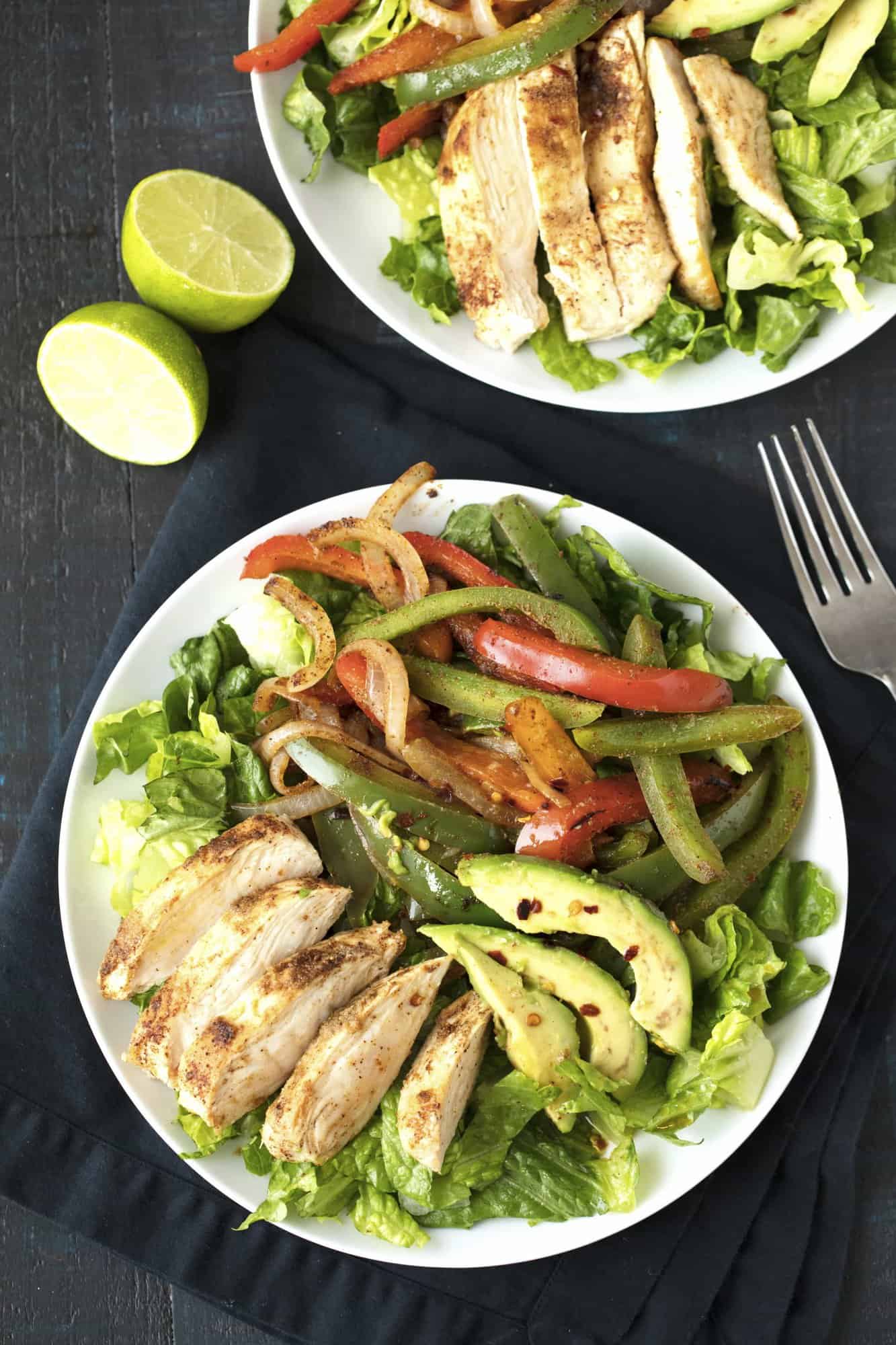 Fajita Salad on a white plate on top of a black towel.