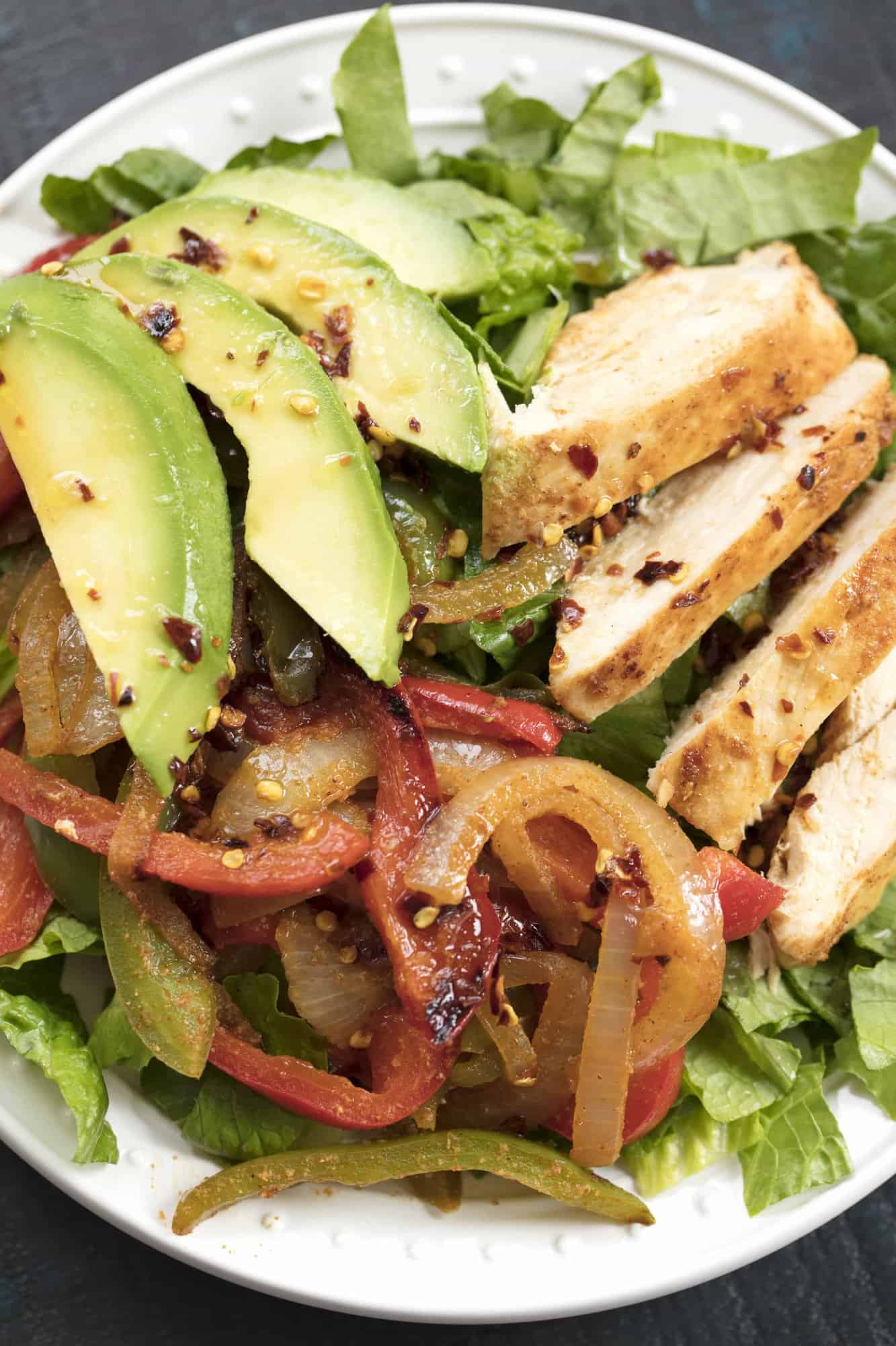 Skinny Chicken Fajita Salad is a recipe you'll use over and over again. This salad is ready in under 15 minute making it the perfect quick healthy lunch or dinner option.