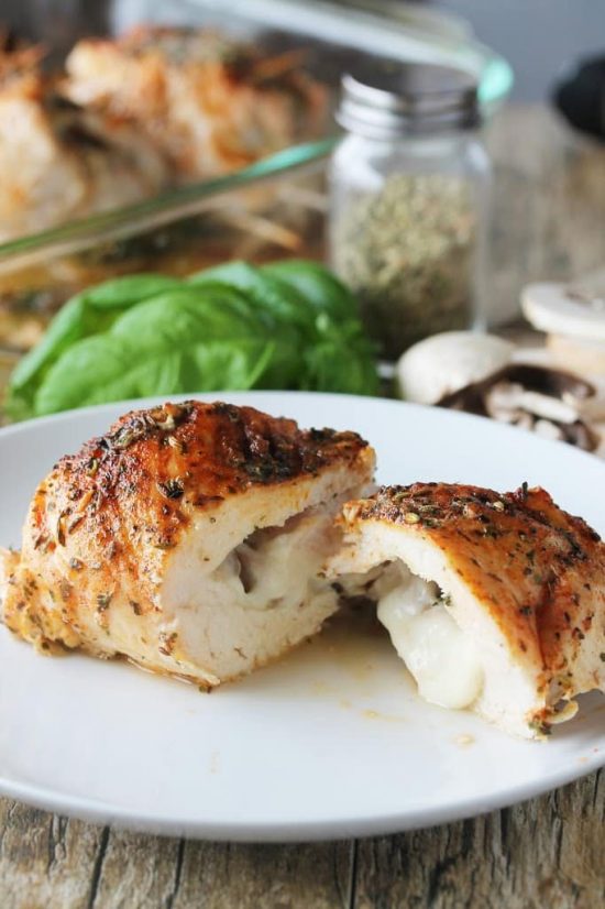 Chicken breasts stuffed with mushrooms and cheese and rubbed with a special mixture of herbs. These Stuffed Herbed Chicken Breasts will wow you! Stuffed herb chicken breast sliced in half with melty cheese