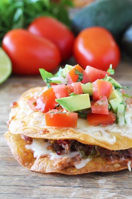 Chalupa with tomato and avocado on top