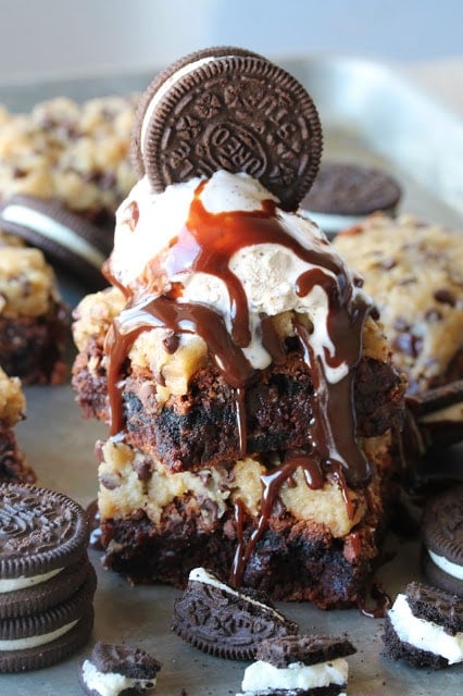 Decadent fudge brownies filled with chunks of Oreo cookies, topped off with raw cookie dough. I call them my Triple Threat Brownies. Oreo Fudge Brownies with Cookie Dough Frosting. What's not to love?