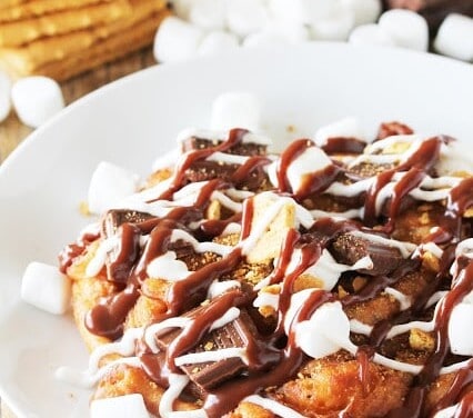 Graham Cracker flavored funnel cake topped with pieces of milk chocolate and mini marshmallows, then drizzled with homemade marshmallow sauce and homemade chocolate sauce