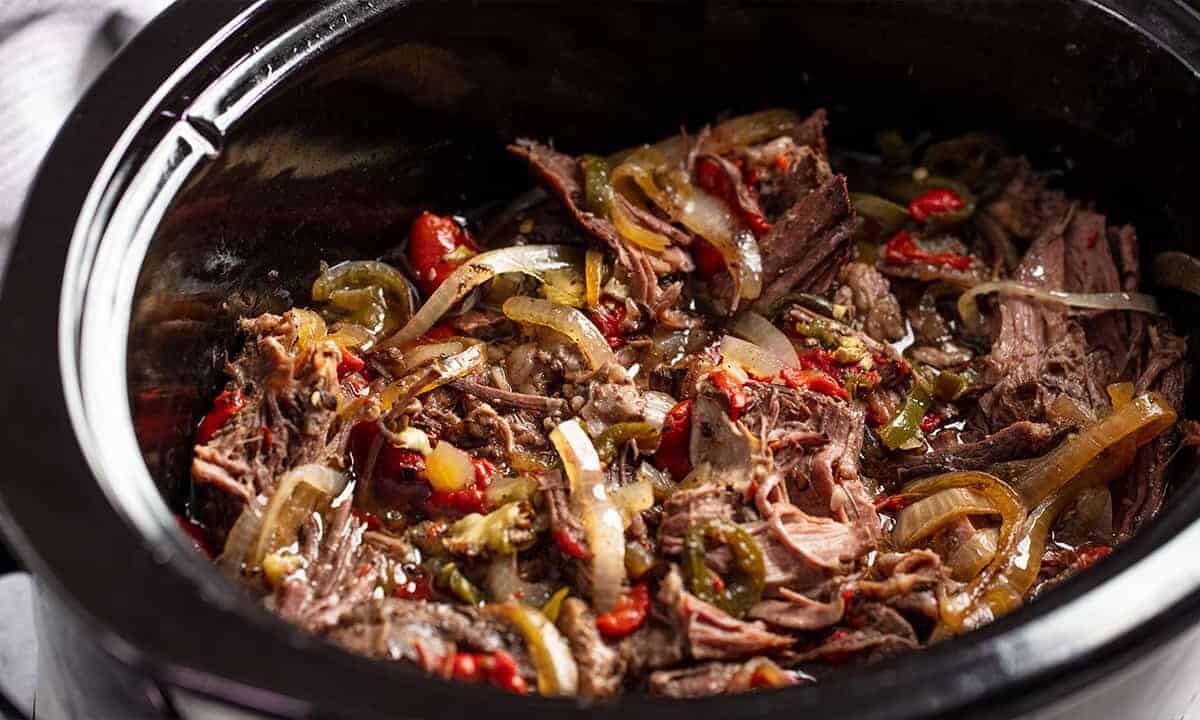 Tender and flavorful shredded beef with peppers and onions, all cooked low and slow in the crockpot.