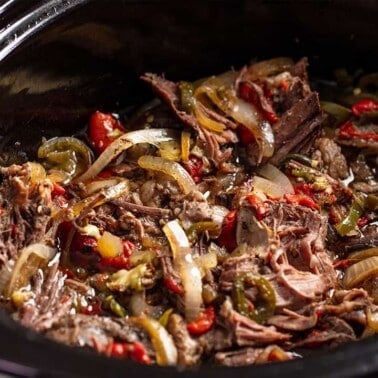 Tender and flavorful shredded beef with peppers and onions, all cooked low and slow in the crockpot.