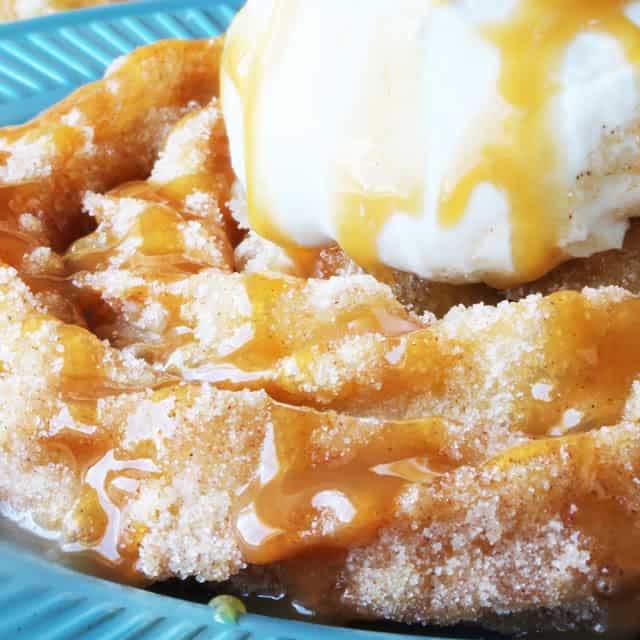 Inspired by Disneyland's delicious Churro Funnel Cakes, this is an easy and decadent dessert. Spiral churro goodness topped with freshly whipped cream and drizzled with caramel sauce.