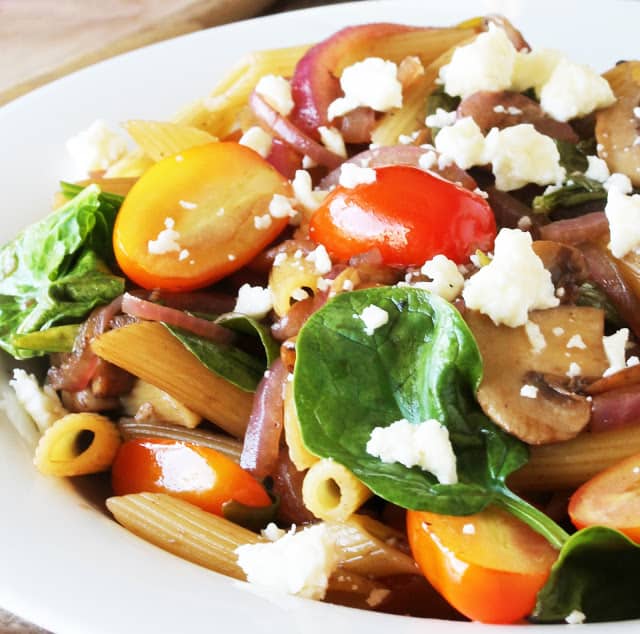 15 Minute Easy Pasta Fresca is full of vegetables for a tasty, light and healthy dinner: Cherry tomatoes, spinach, mushrooms and onion pasta and topped with crumbled feta cheese