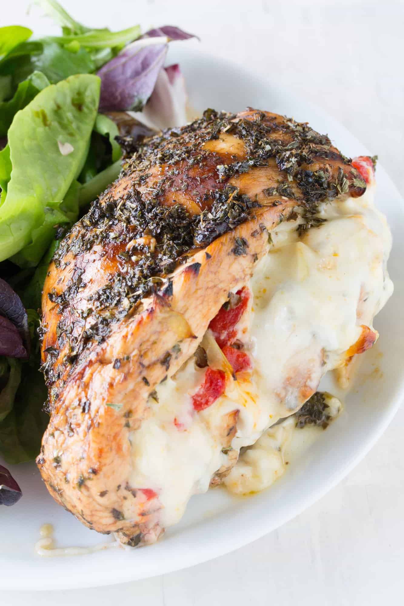 Balsamic and herb glazed chicken, stuffed with artichoke, bell pepper, and fennel. This Italian Stuffed Chicken will tickle your tastebuds!