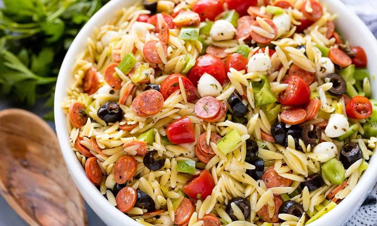 Classic Italian orzo pasta salad, complete with a homemade dressing and mini pepperonis. This traditional American pasta salad is great with an orzo pasta twist.