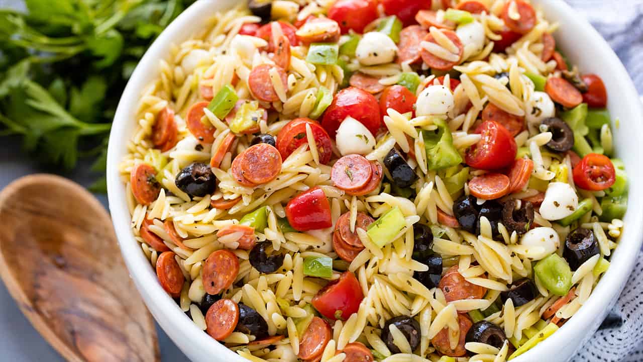 Classic Italian orzo pasta salad, complete with a homemade dressing and mini pepperonis. This traditional American pasta salad is great with an orzo pasta twist.