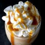 Top view of a salted caramel frappe topped with whipped cream and caramel.