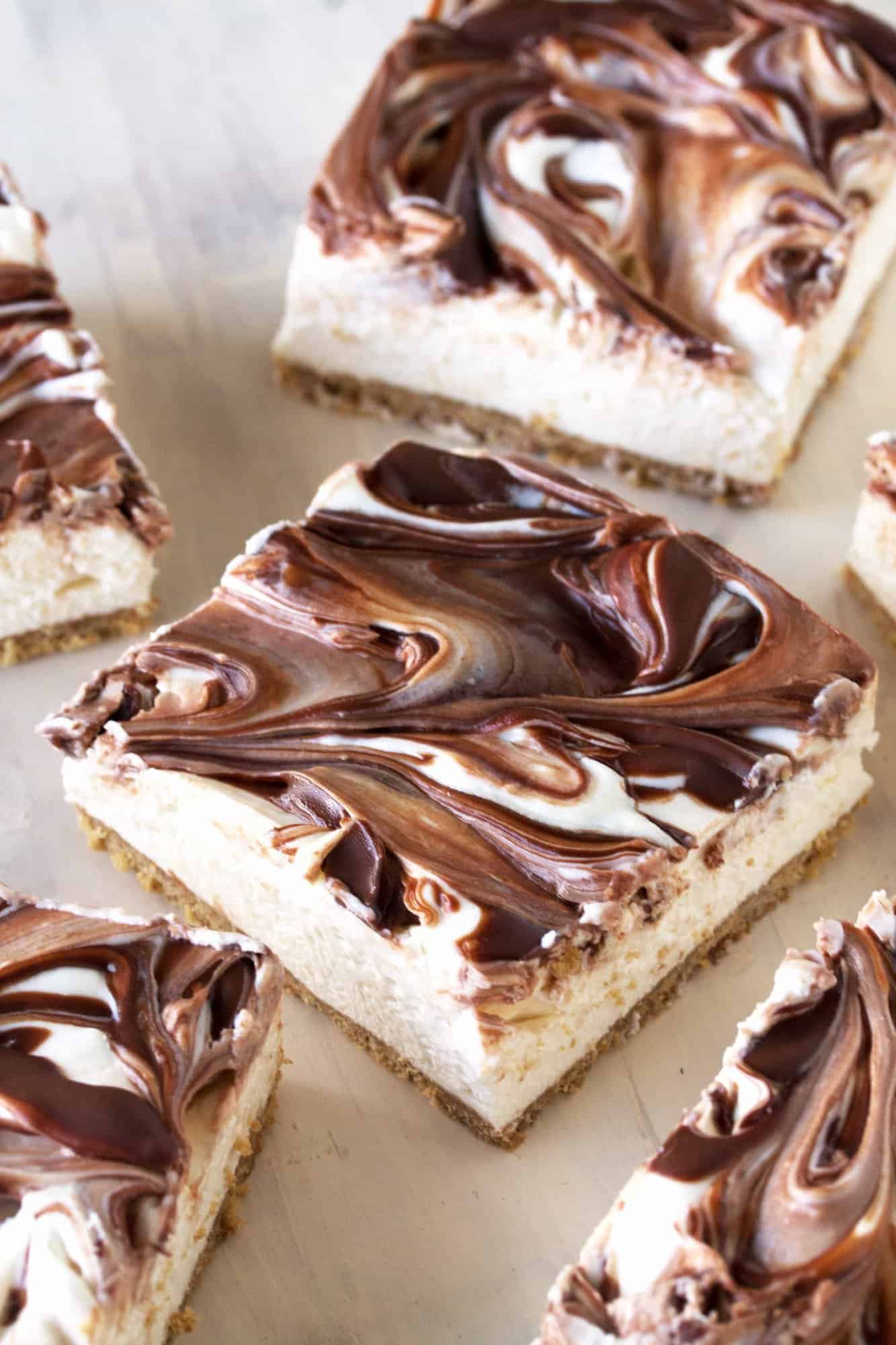 Light and fluffy cheesecake swirled with creamy Nutella sits on top of a graham cracker crust. Your tastebuds will swoon over this No Bake Nutella Swirl Cheesecake.