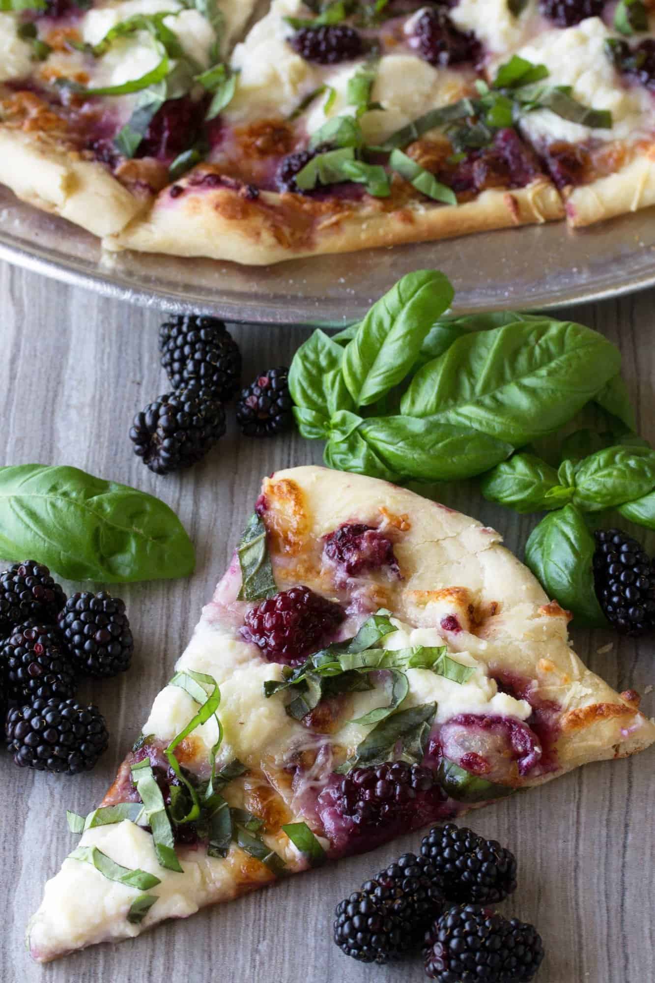 A slice of blackberry basil ricotta pizza.