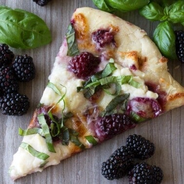 A slice of blackberry basil ricotta pizza.