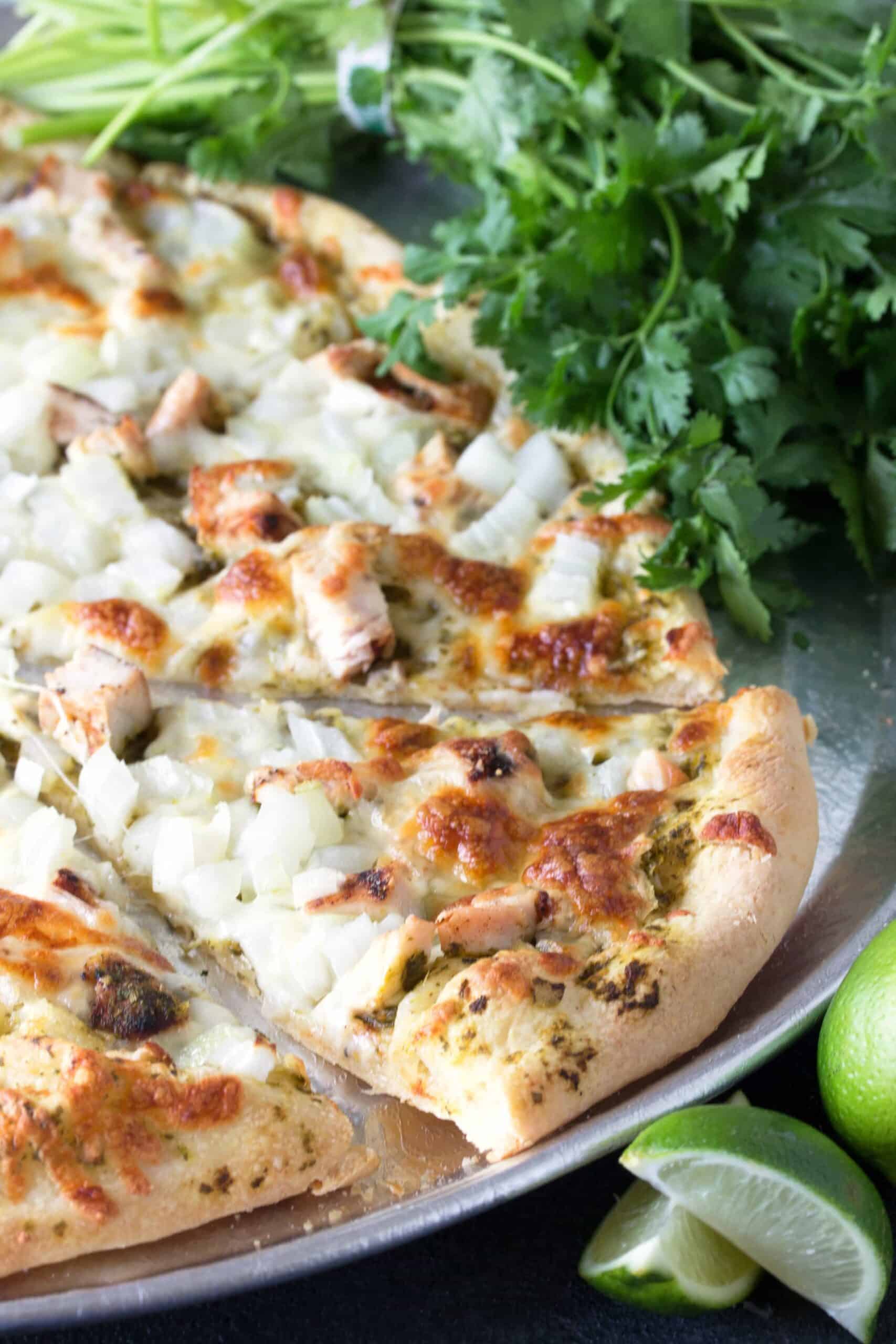 Cilantro Lime Chicken Pizza with a slice cut out.