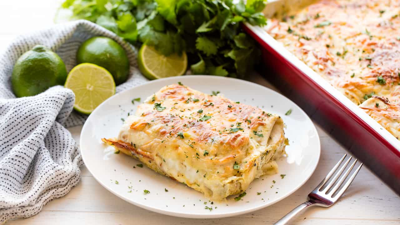 Green Chile Chicken Enchiladas are a classic American family favorite! This recipe is easy to make and is ready for the oven in less than 15 minutes.