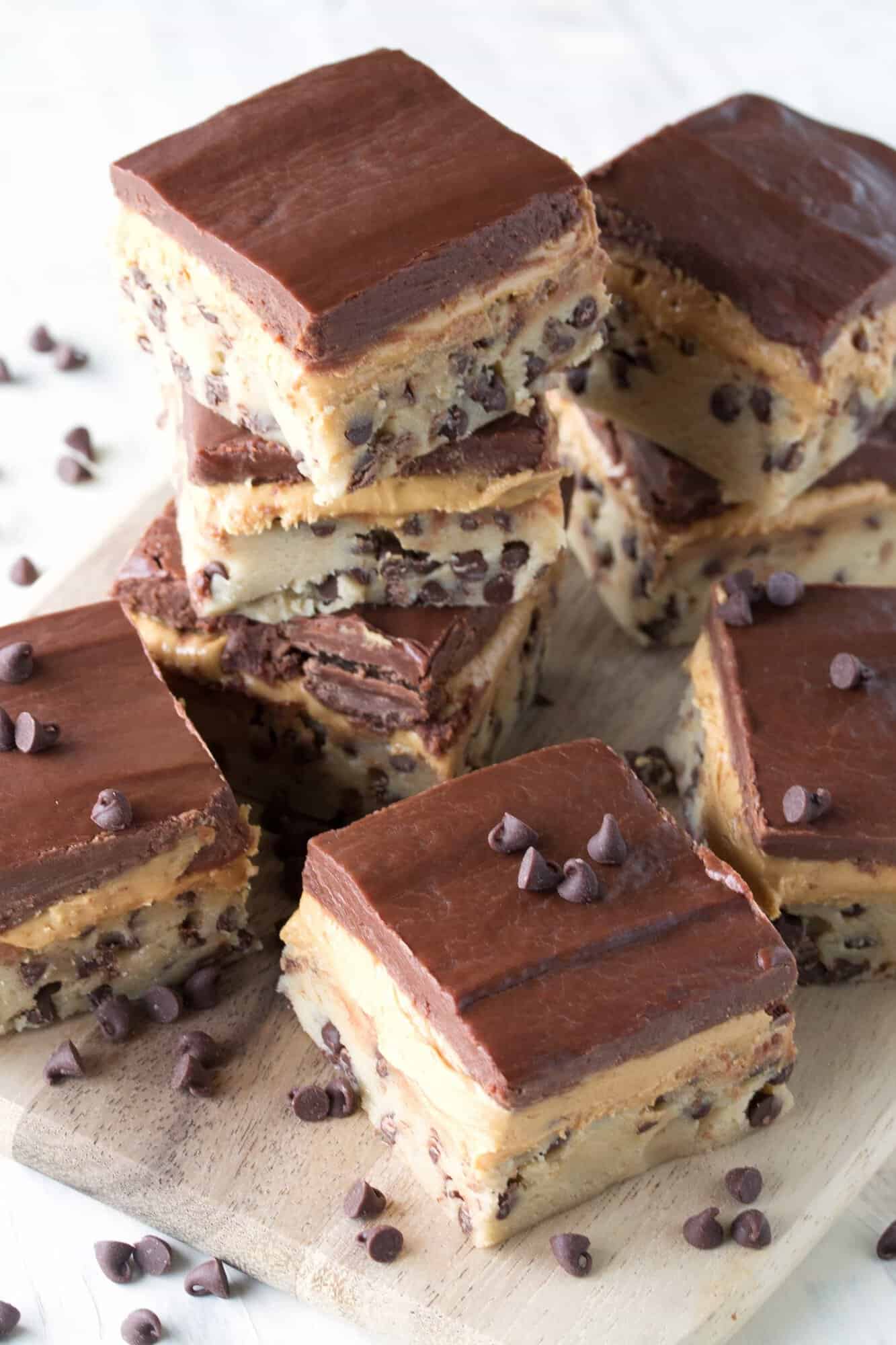 Chocolate chip cookie dough, peanut butter cup filling, and a chocolate ganache create three layers of no bake goodness. No Bake Peanut Butter Chocolate Chip Cookie Dough Bars are simply irresistible!