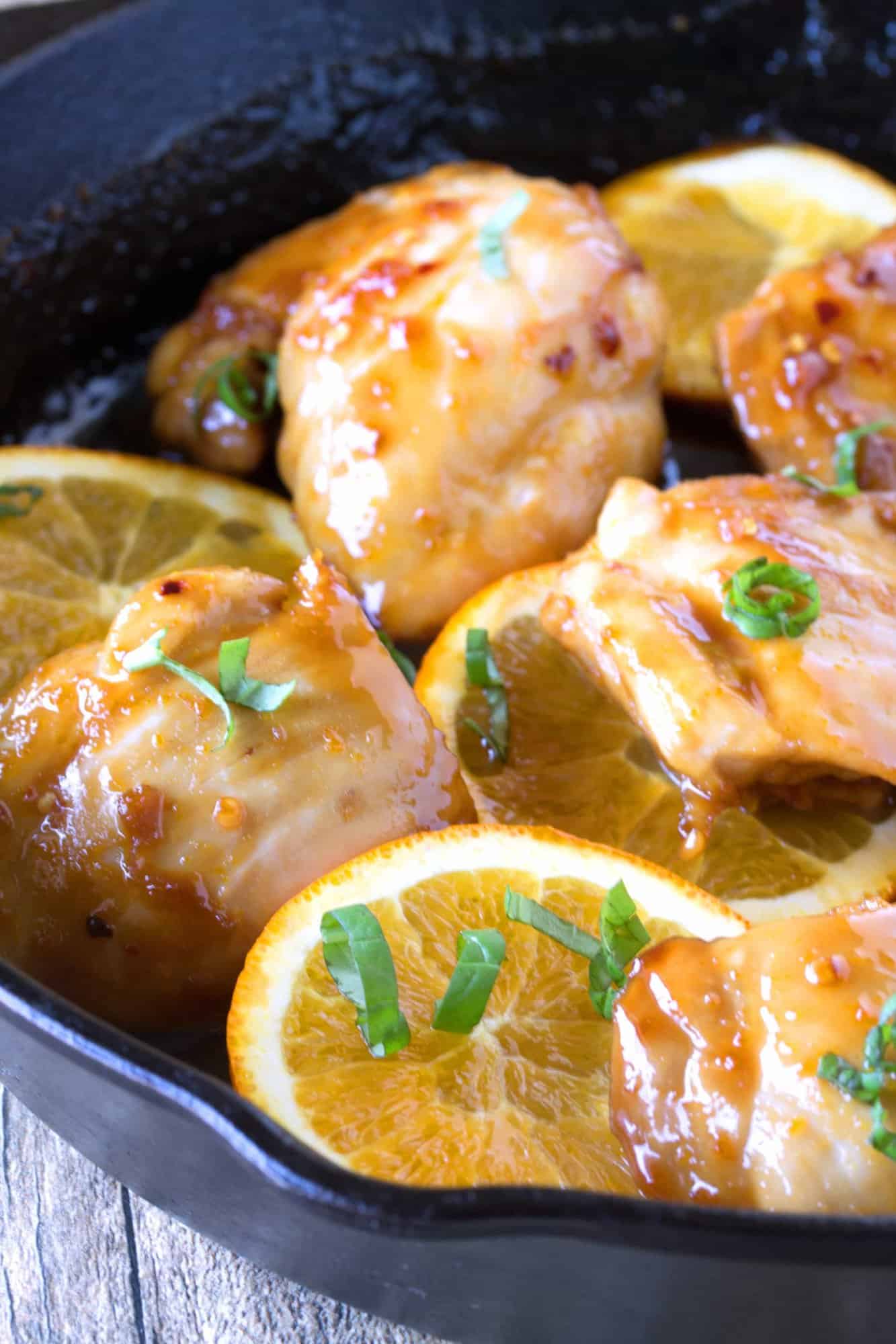 Close up of Orange Glazed Chicken Thighs in a skillet.